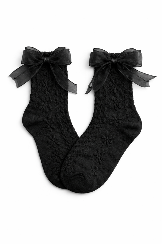 Flat lay of the Innocent Mischief Lace Socks in black with tulle bow.