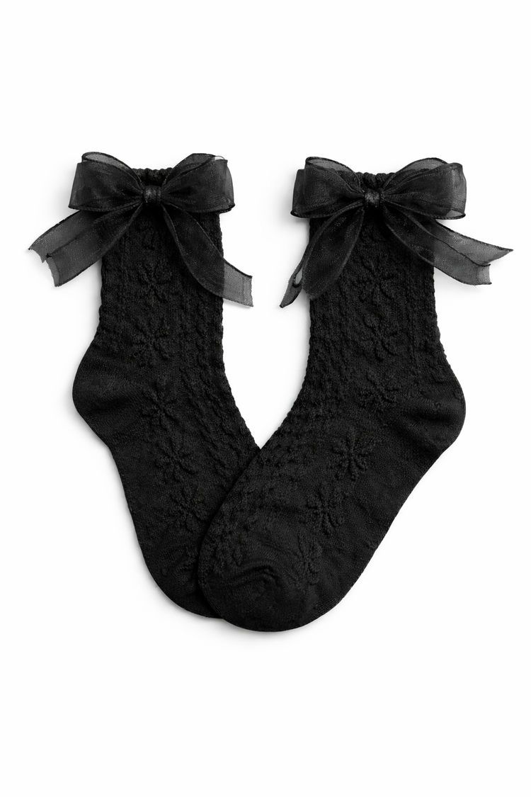 Flat lay of the Innocent Mischief Lace Socks in black with tulle bow.