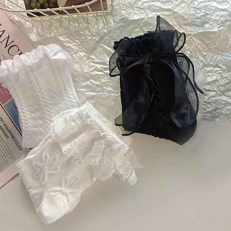 Folded view of the Innocent Mischief Lace Socks in white and black in all three styles.