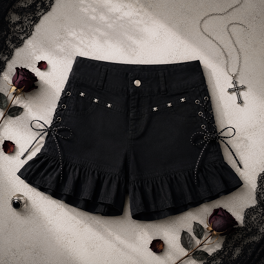 Two Moody Originals: Pretty Dangerous Shorts styled with gothic-inspired accessories, featuring custom ruffle hems, skull embellishments, and studded ribbon side lacing.
