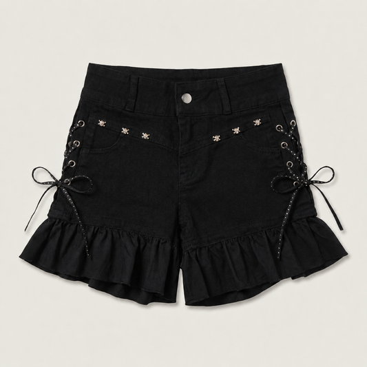 Two Moody Originals: Pretty Dangerous Shorts in black denim with custom ruffle hems, skull embellishments, and studded ribbon side lacing.