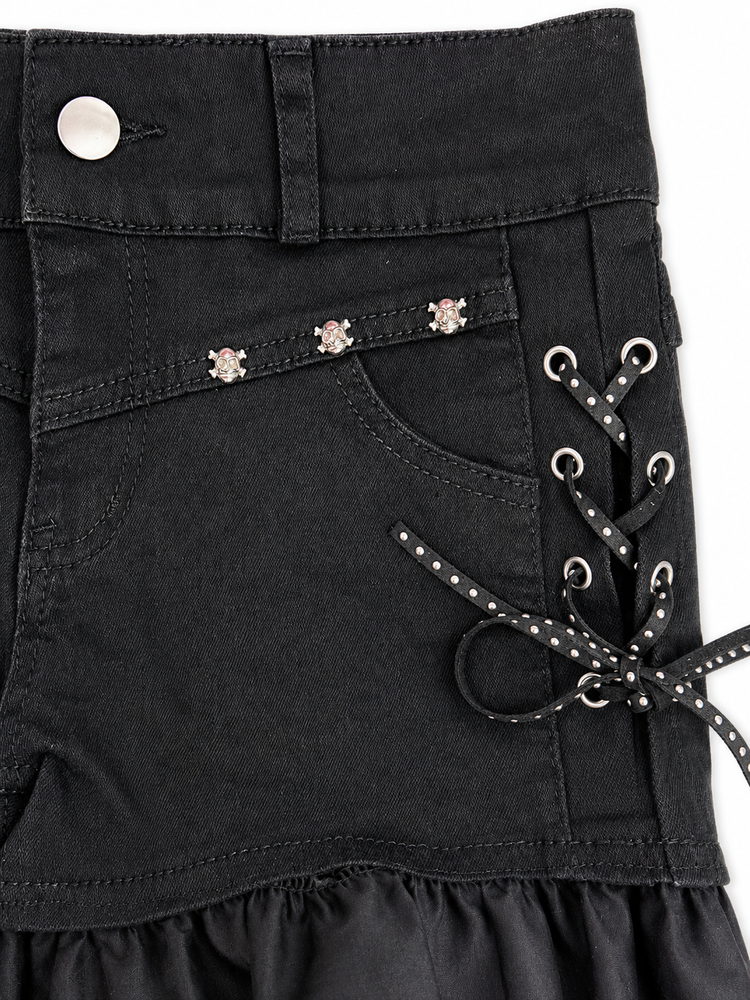 Detailed view of Two Moody Originals: Pretty Dangerous Shorts featuring studded ribbon side lacing, metal grommets, and skull embellishments.