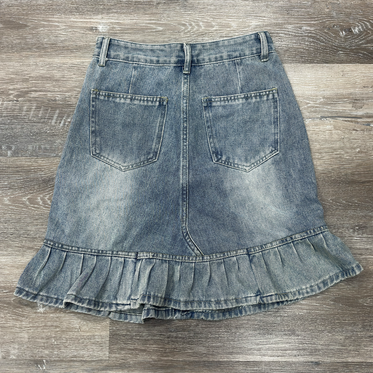 Back flat lay of the Two Moody Originals: Ruffle Flare Jean Skirt with Angled Front in size M with ruffle hem.