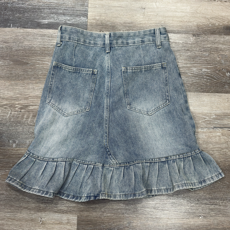 Back flat lay of the Two Moody Originals: Ruffle Flare Jean Skirt with Angled Front in size S with ruffle hem.