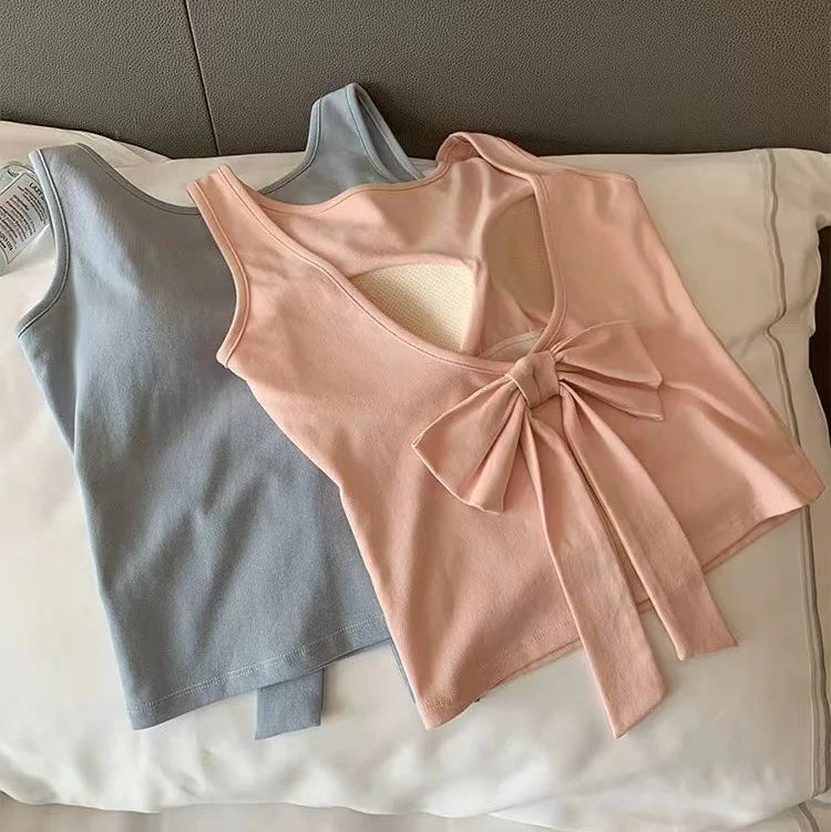 Back view of the pink Backstage Bow Backless Tank, featuring an oversized bow detail, against the front view of the blue version.
