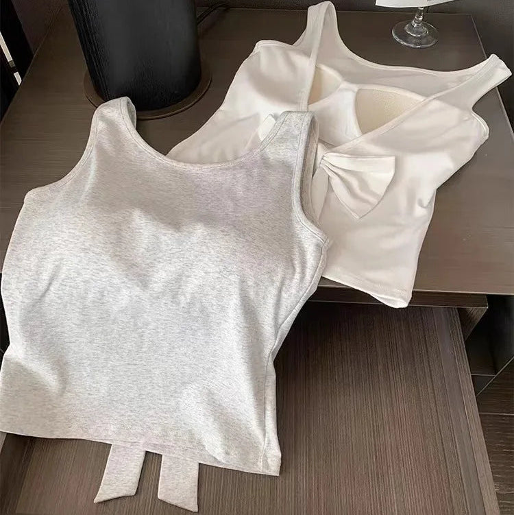 Backstage Bow Backless Tank in white and gray laid flat, the gray displaying the front and the white displaying the back.