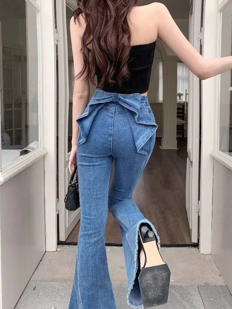 Closer back view of the Dark Blue Backstage Bow Flare Jeans, showcasing the bow detail and hem.