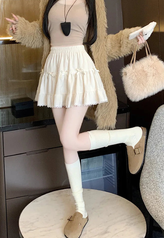 Side view of Bow Peep Mini Skort in Apricot showing lace-trim hem.