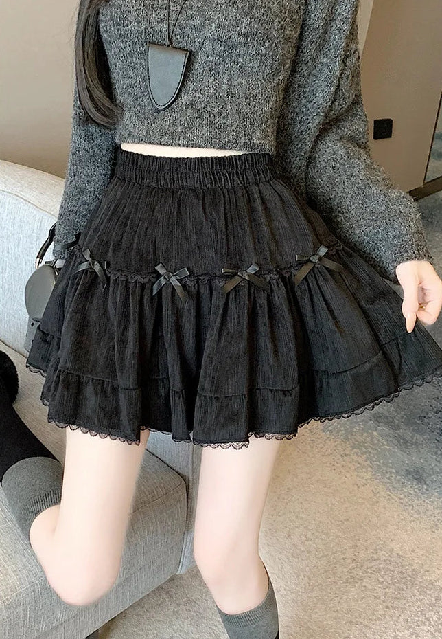 Close-up shot of Bow Peep Mini Skort in Black, showcasing its pleats and bows.