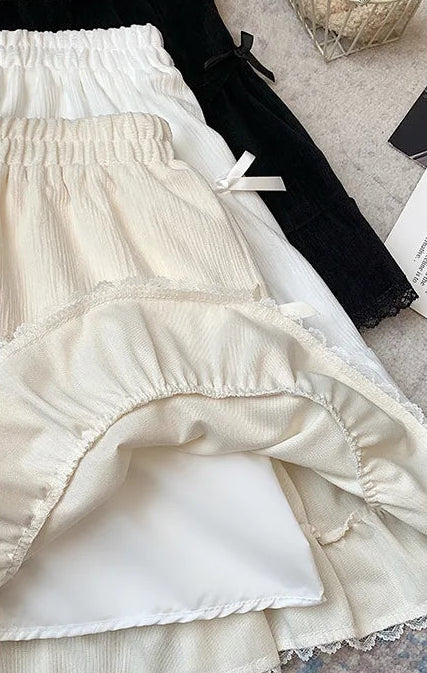 The three colors of the Bow Peep Mini Skorts stacked on top of each other with the apricot version on top, showing the shorts underneath.