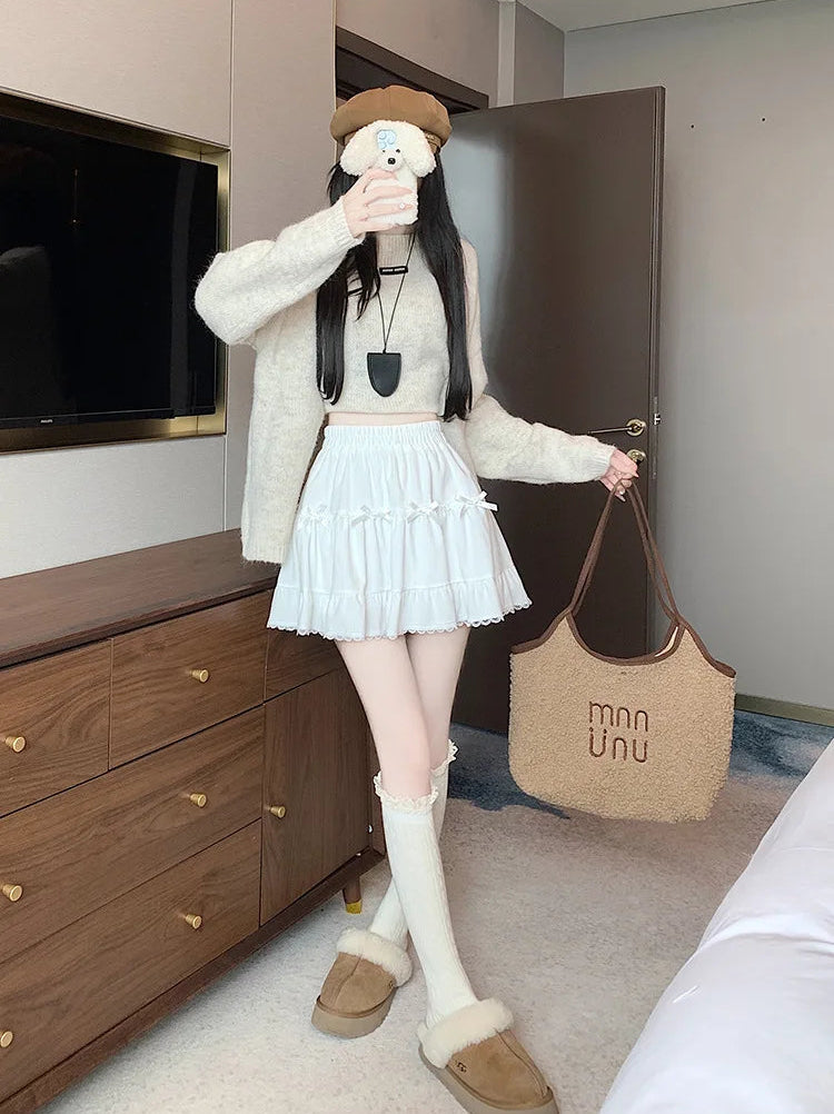 Model posing in the Bow Peep Mini Skort in White.