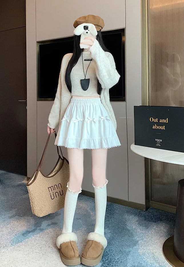 Model taking a selfie in the Bow Peep Mini Skort in White.