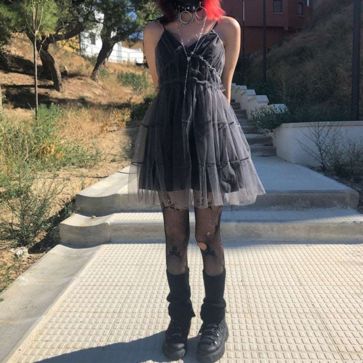 Model wearing Dark Fairy Tulle Dress outdoors full-body view, styled with black shoes, black leg warmers, and fishnet skull tights