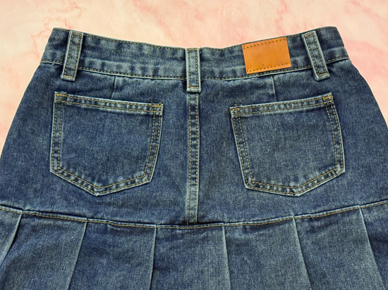 Close-up of back waist and pockets on the Denim Daydream Pleated Lace Skort