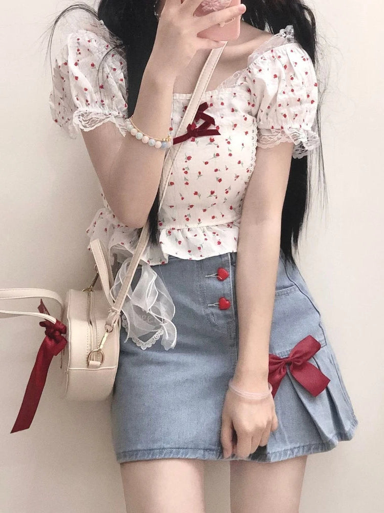 The Dual Darling Denim Skirt paired with a puff-sleeve floral top, showing off the contrast between its pleated and smooth sides