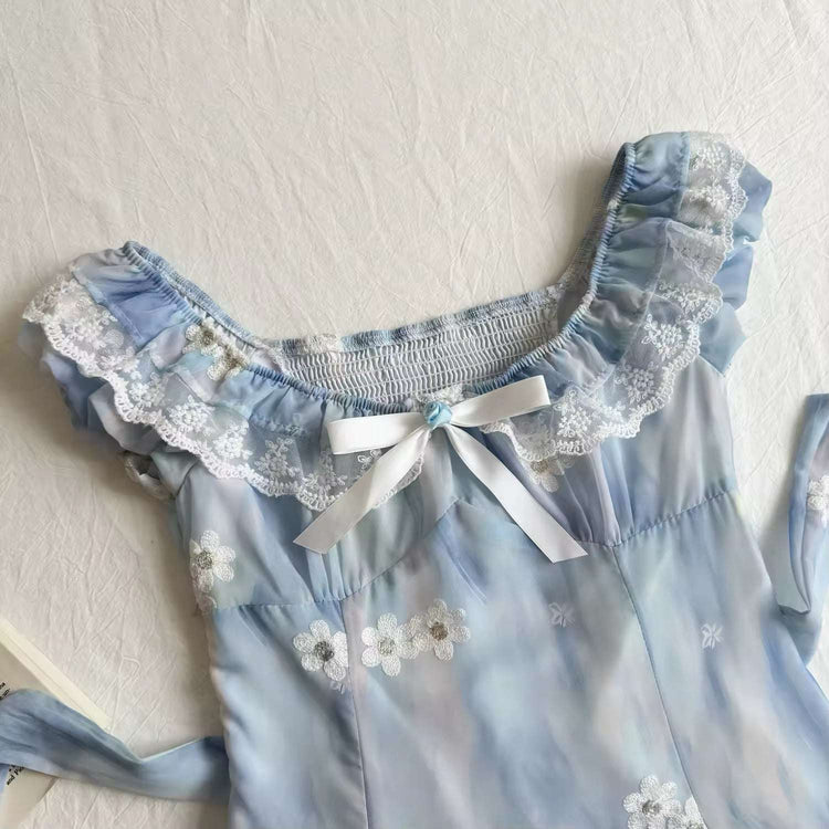 Close-up of the neckline of the midi Ethereal Flower Princess Dress, showcasing its lace trim, bow detailing, floral embellishments, and back ties.