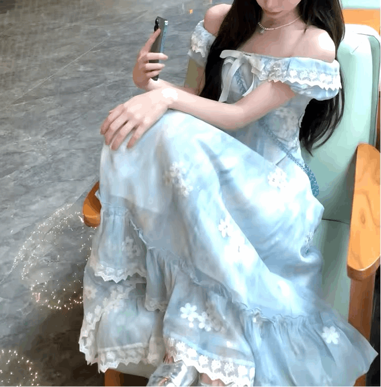 Model sitting on a chair with her feet on the seat wearing the midi version of the Ethereal Flower Princess Dress.