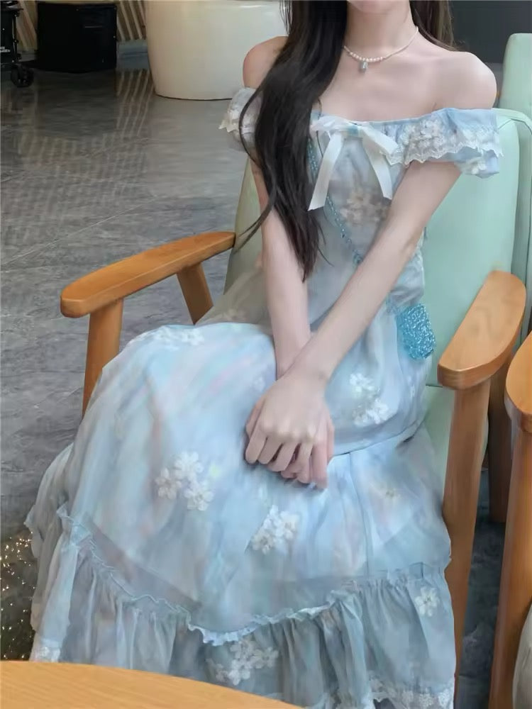 Model sitting with cross arms wearing the midi version of the Ethereal Flower Princess Dress.