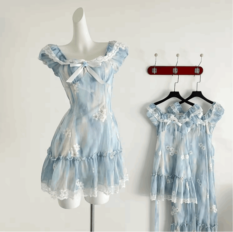 The mini Ethereal Flower Princess Dress on a mannequin, with the mini and midi versions of the dress hanging on the wall behind it.