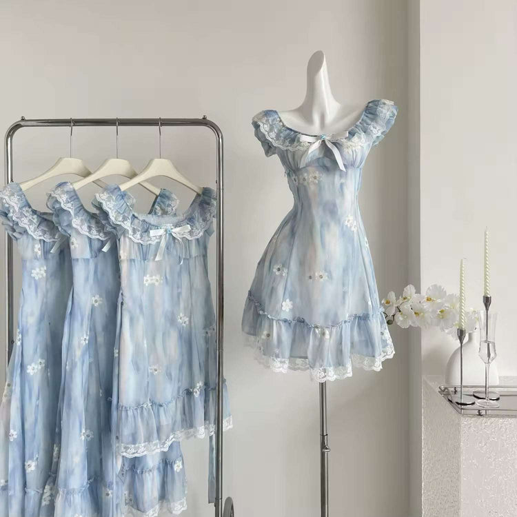 The mini Ethereal Flower Princess Dress on a mannequin next to a rack with the mini and midi versions of the dress hanging on it.
