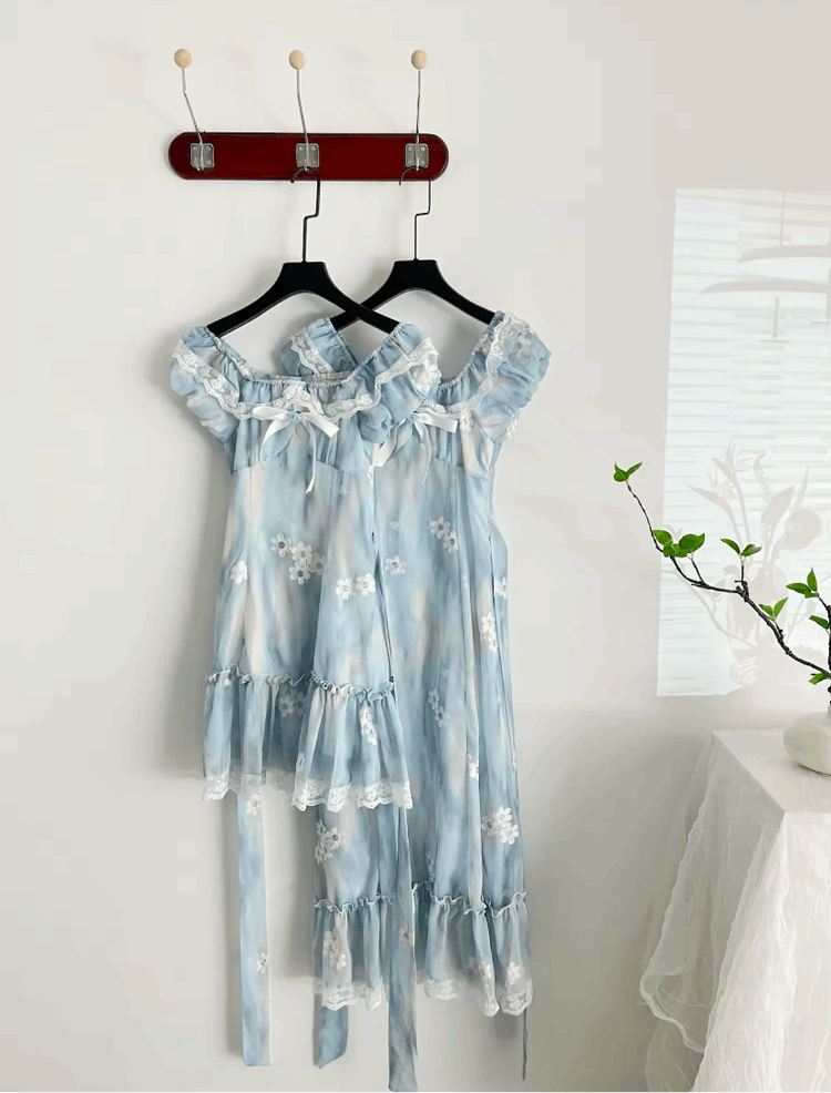 The mini and midi versions of the Ethereal Flower Princess Dress hanging side by side on a wall.