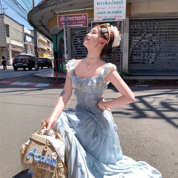 Closer view of daisy embroidery at neckline and 3D floral appliqués on the Ethereal Flower Princess Heavenly Bloom Midi Dress in light blue.