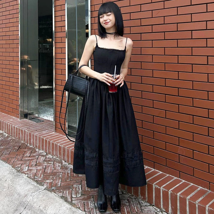 Model smiling and holding a drink while the Midnight Sonata Corset Dress.