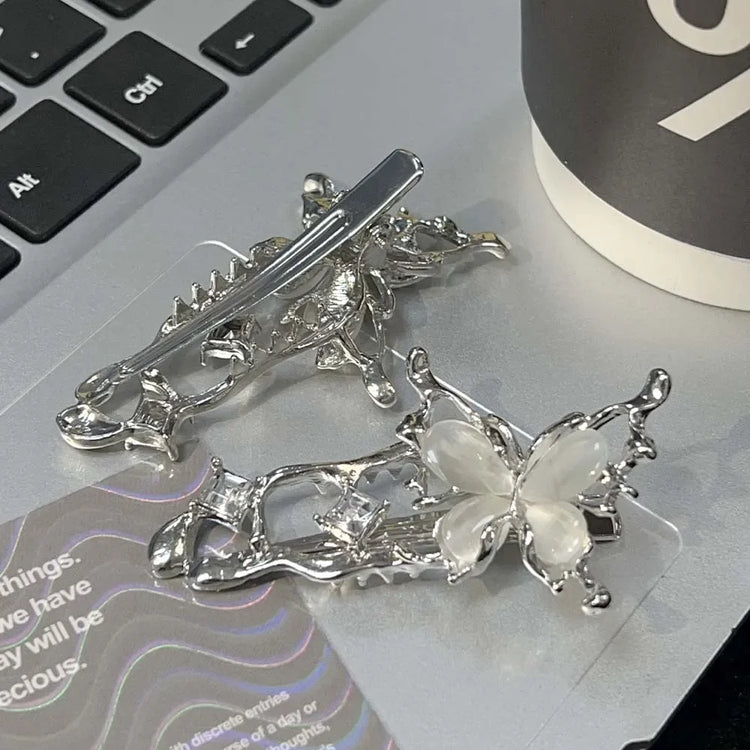 Close-up of the Liquid Metal Butterfly Hair Clip’s front and back, showing the metallic clasp and butterfly wing detail.