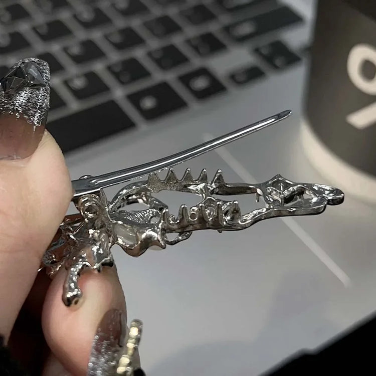 Close-up of the Liquid Metal Butterfly Hair Clip’s hinge showing the metallic clasp and butterfly wing detail.