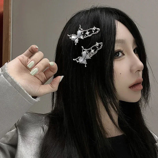 Side profile of a model with black hair wearing two Liquid Metal Butterfly Hair Clips.