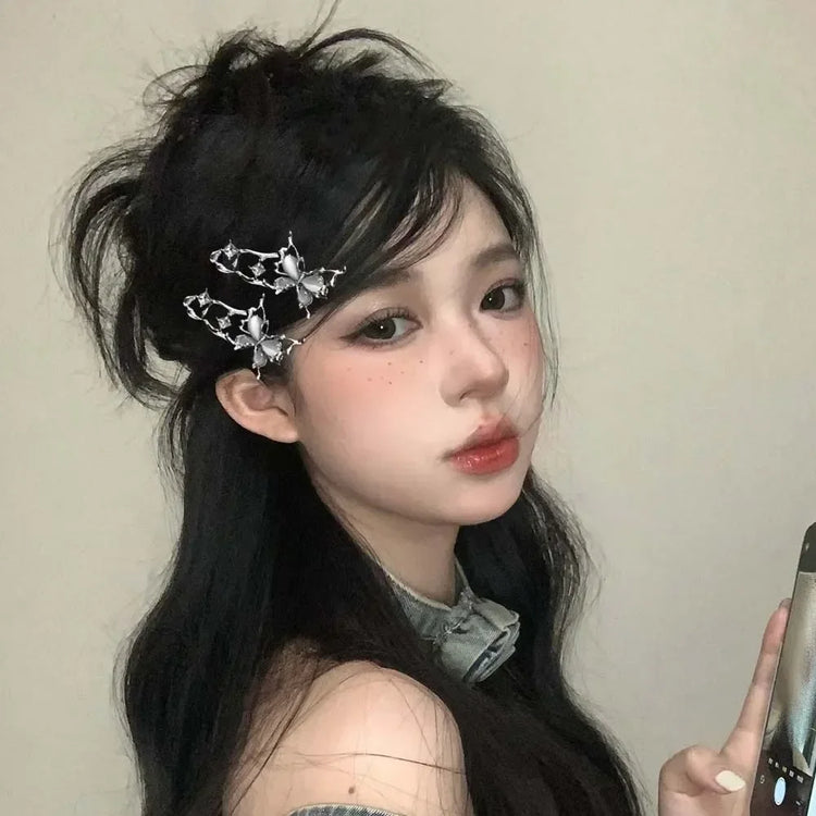 Side profile of a model with black hair wearing multiple Liquid Metal Butterfly Hair Clips.