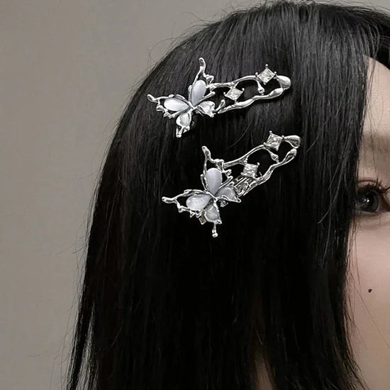 Model with straight black hair wearing two Liquid Metal Butterfly Hair Clips.