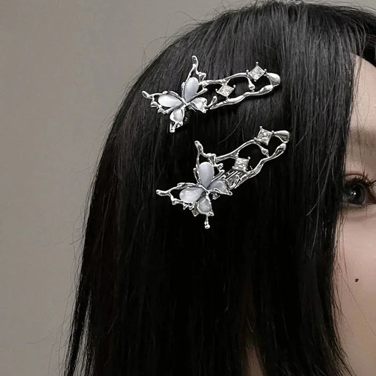 Model with straight black hair wearing two Liquid Metal Butterfly Hair Clips.