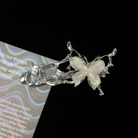 Close-up of a single Liquid Metal Butterfly Hair Clip with reflective silver butterfly wings.