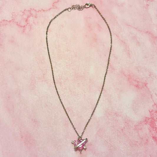 Flat lay of Love Orbit Necklace with pink heart and orbit-style stones