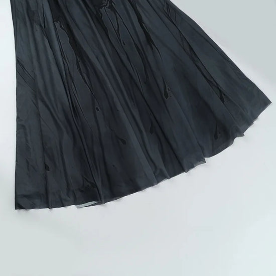 Flat lay front view of the Midnight Butterfly Maxi Dress with skirt spread to highlight pleated flow.