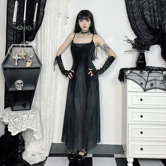 Model standing with hands on hips wearing the Midnight Butterfly Maxi Dress, showing the waistline and butterfly pattern.