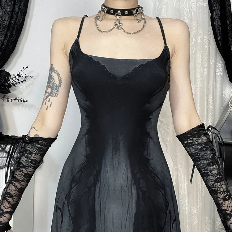 Model showing the front of the Midnight Butterfly Maxi Dress with arms extended to reveal straps and print details.