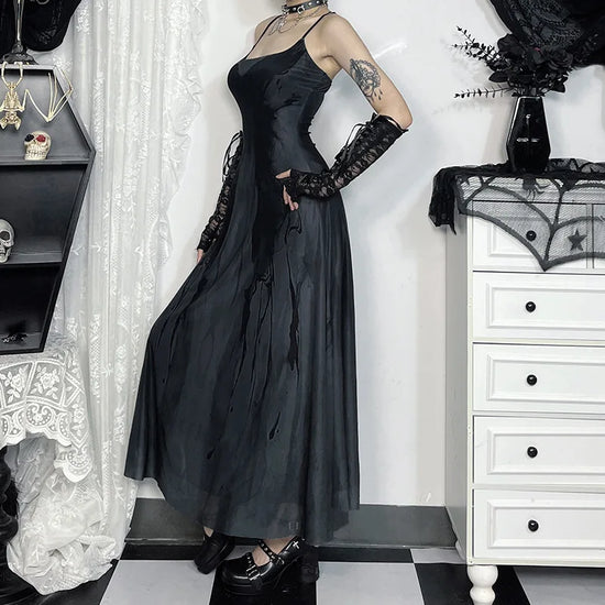Model turned to the side, standing with hands on hips, wearing the Midnight Butterfly Maxi Dress, showcasing the flowy silhouette.