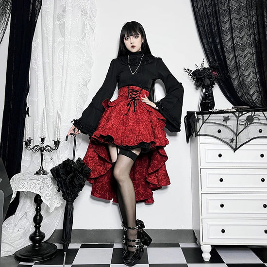 Model posing with on hip wearing the red Midnight Masquerade High-Low Skirt