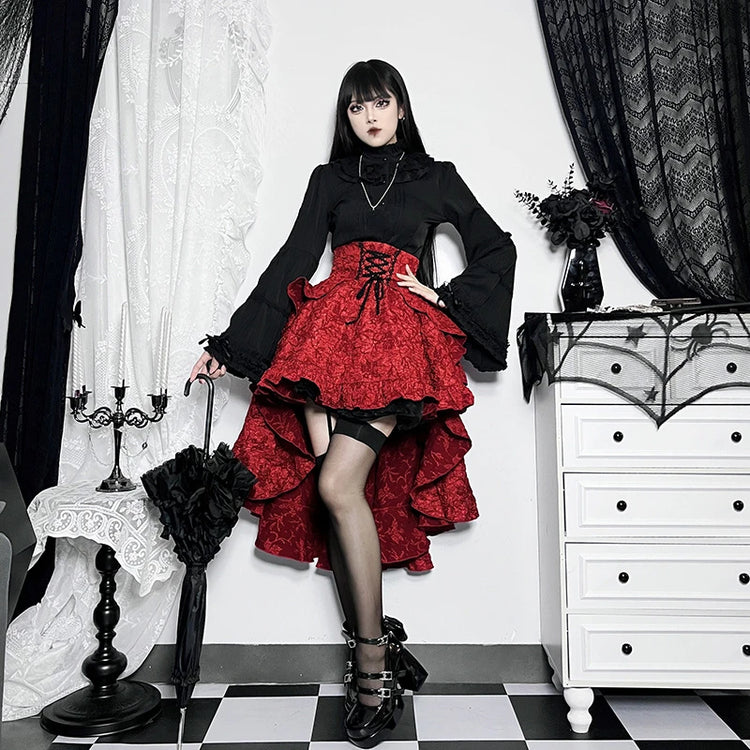 Model posing with on hip wearing the red Midnight Masquerade High-Low Skirt