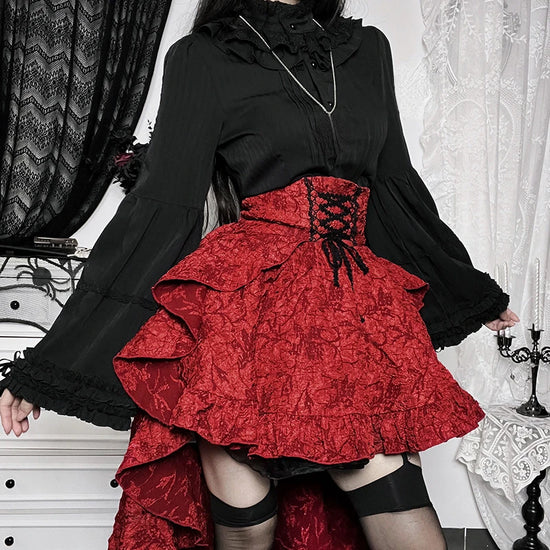 Model close-up showing red Midnight Masquerade High-Low Skirt's corset-style front and floral print detail