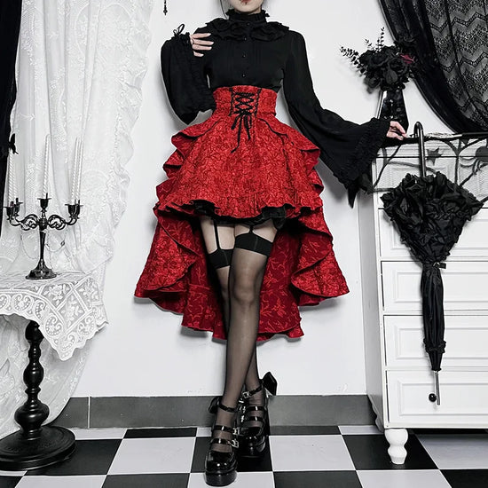 Model standing with legs crossed in red Midnight Masquerade High-Low Skirt