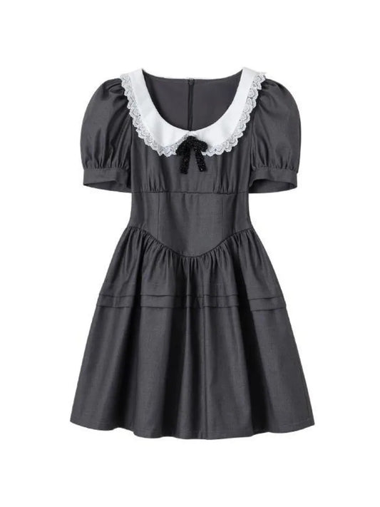 Flat lay of the Midnight Mourning Baby Doll Dress, showing seamed skirt, lace-trimmed collar, and bow