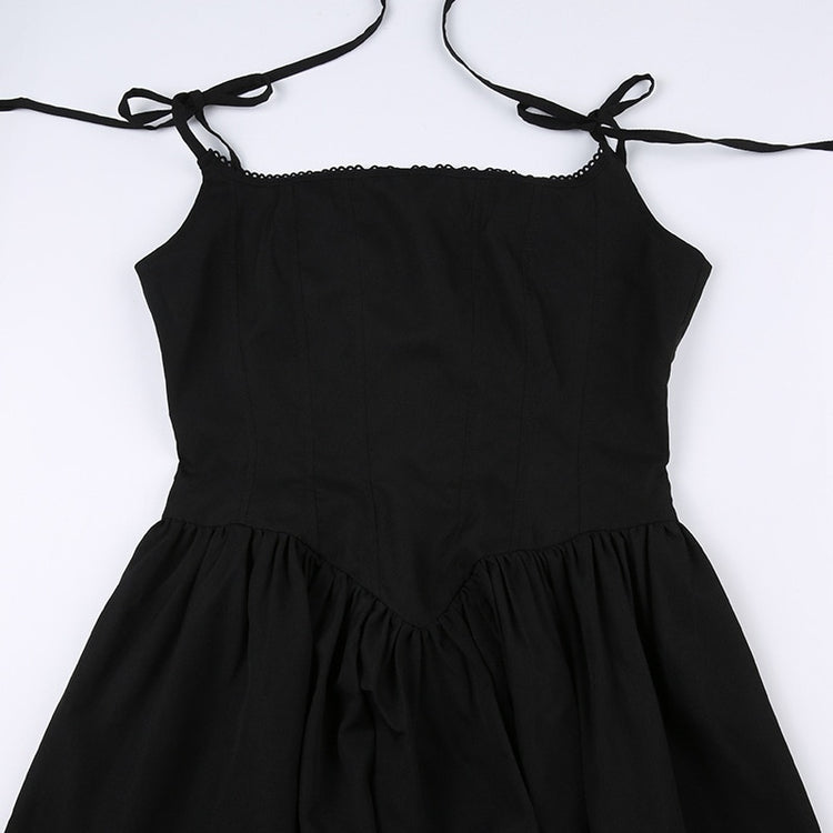 Flat lay close-up of the corset-inspired detailing and tie straps on the front of the Midnight Sonata Corset Dress.