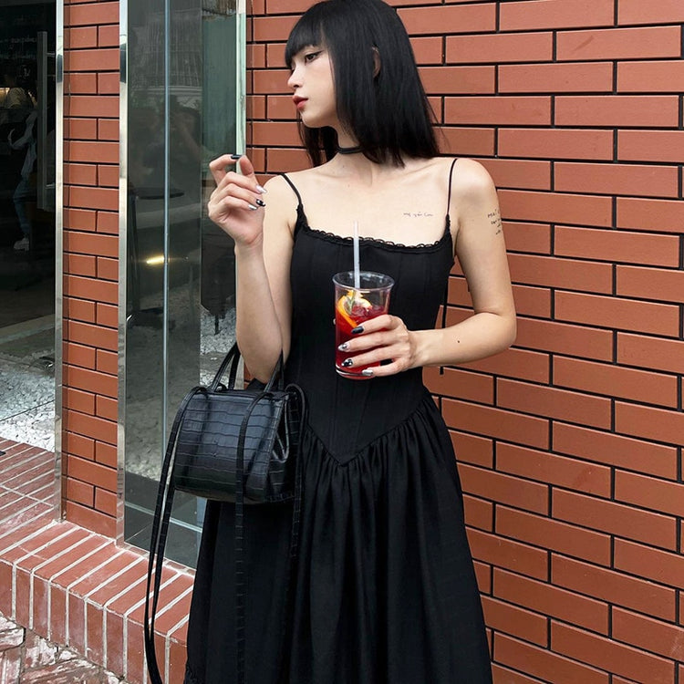 Close-up of the corset bodice of the Midnight Sonata Corset Dress with a black purse accessory.
