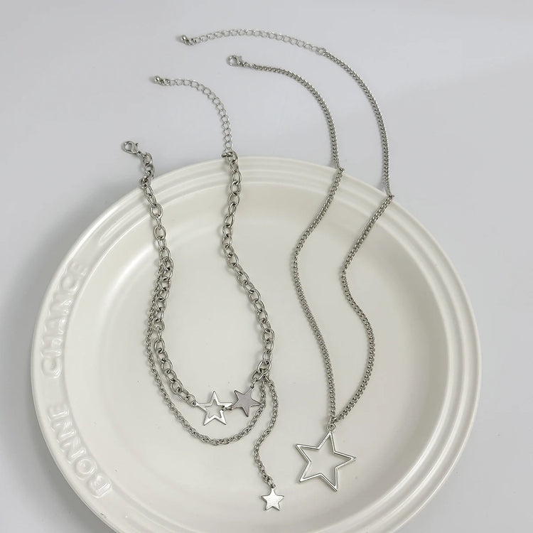 Orbit Dreams Necklace flat lay featuring silver layered chains and celestial star charms