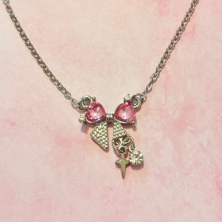 Detailed, close-up shot of Pink Crystal Bow Necklace chain and pendant connection