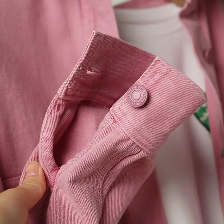 Close-up of the Pink Petal Denim Overshirt showcasing the buttoned sleeve cuff and soft pink denim fabric.