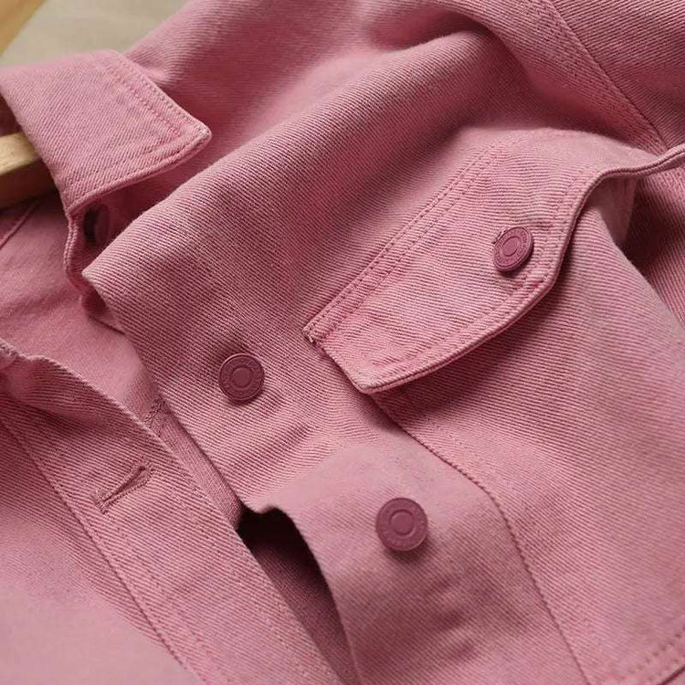 Close-up of the Pink Petal Denim Overshirt, highlighting the chest pocket and matching pink buttons.